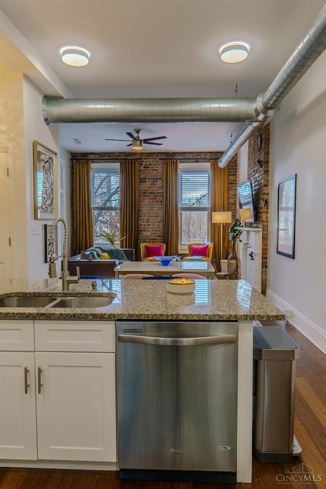 306 Mulberry St Unit 2, Cincinnati, OH 45202 - kitchen featuring stainless steel dishwasher, light stone counters, white cabinets, ceiling fan, and brick wall