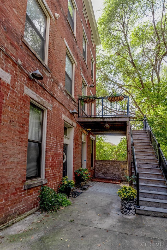 306 Mulberry St Unit 2, Cincinnati, OH 45202 - view of side of property featuring brick siding, stairs, and a patio area