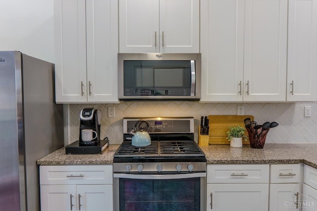 306 Mulberry St Unit 2, Cincinnati, OH 45202 - kitchen featuring stainless steel appliances, white cabinetry, backsplash, and light stone counters