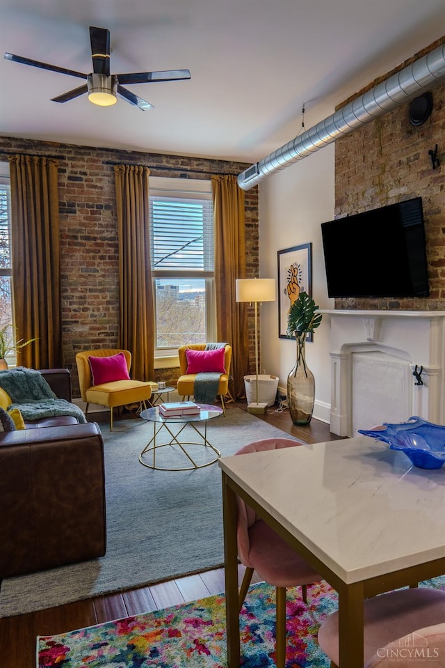 306 Mulberry St Unit 2, Cincinnati, OH 45202 - living room featuring wood finished floors, ceiling fan, a fireplace, and brick wall