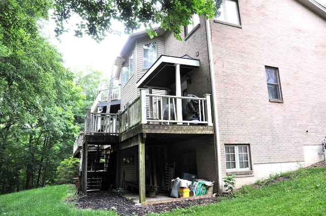 8030 Deershadow Ln, Montgomery, OH 45242 - rear view of property with brick siding, stairs, a lawn, and a deck