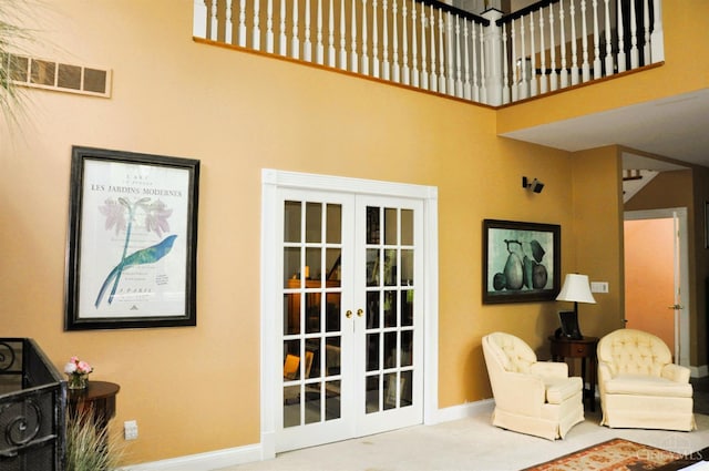 8030 Deershadow Ln, Montgomery, OH 45242 - carpeted living room with french doors and a towering ceiling