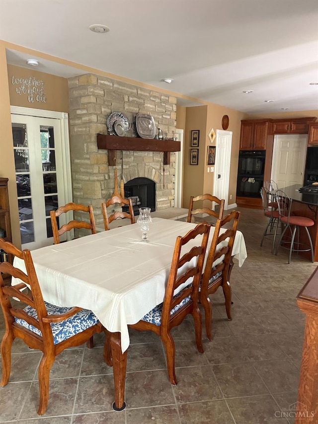 8030 Deershadow Ln, Montgomery, OH 45242 - dining room featuring a fireplace and dark tile patterned flooring