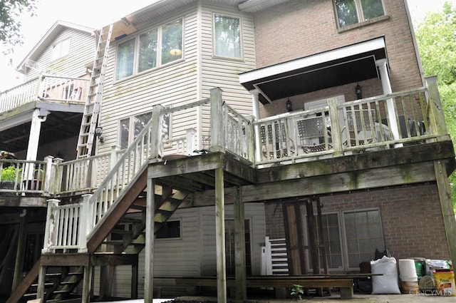 8030 Deershadow Ln, Montgomery, OH 45242 - rear view of property featuring stairs, brick siding, and a wooden deck