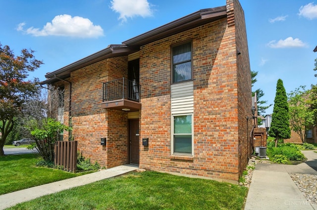 55 Stillmeadow Dr, Pierce Twp, OH 45245 - view of front of property featuring a balcony, a front lawn, a chimney, and brick siding