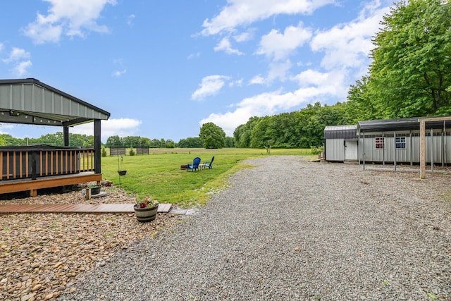 13726 New Harmony Shiloh Rd, Pike Twp, OH 45154 - view of grassy yard featuring a carport and an outbuilding