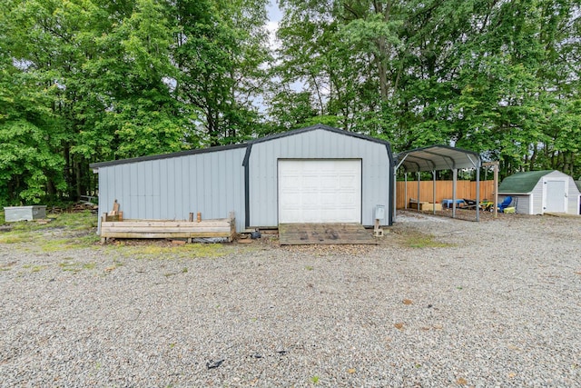 13726 New Harmony Shiloh Rd, Pike Twp, OH 45154 - detached garage featuring a shed, view of wooded area, and a detached carport