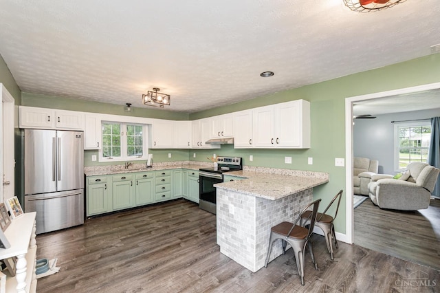 13726 New Harmony Shiloh Rd, Pike Twp, OH 45154 - kitchen featuring appliances with stainless steel finishes, a peninsula, white cabinetry, dark wood-type flooring, and light stone countertops