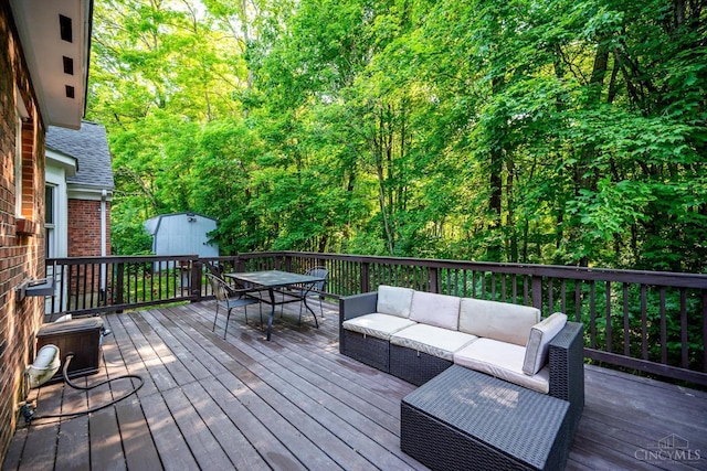 9930 Tall Oaks Ct, Deerfield Twp, OH 45140 - wooden terrace featuring outdoor dining area, outdoor lounge area, a shed, and a forest view