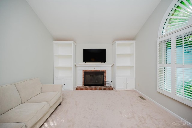 9930 Tall Oaks Ct, Deerfield Twp, OH 45140 - carpeted living area with lofted ceiling, plenty of natural light, a brick fireplace, and built in features
