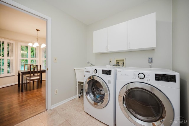 9930 Tall Oaks Ct, Deerfield Twp, OH 45140 - washroom with cabinet space, a chandelier, washing machine and clothes dryer, and light tile patterned flooring
