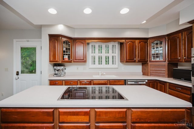 9930 Tall Oaks Ct, Deerfield Twp, OH 45140 - kitchen featuring black electric cooktop, light countertops, glass insert cabinets, a kitchen island, and recessed lighting