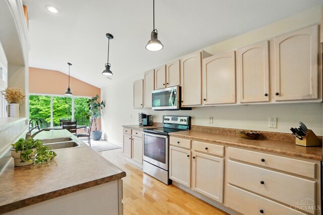 3492 Ballymore Ct, Pierce Twp, OH 45245 - kitchen with appliances with stainless steel finishes, vaulted ceiling, light wood-style floors, hanging light fixtures, and recessed lighting