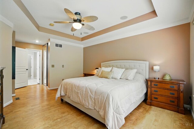 3492 Ballymore Ct, Pierce Twp, OH 45245 - bedroom featuring a raised ceiling, light wood-style floors, and a ceiling fan