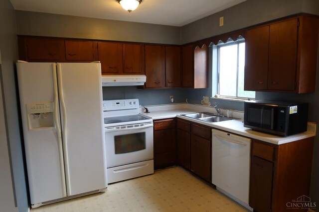 704 Trafalgar Ct, Middletown, OH 45044 - kitchen featuring white appliances, under cabinet range hood, light countertops, light floors, and brown cabinets
