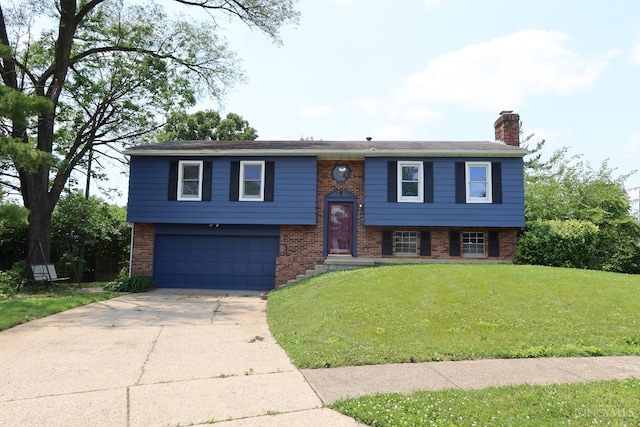 704 Trafalgar Ct, Middletown, OH 45044 - bi-level home with brick siding, a chimney, a garage, and driveway