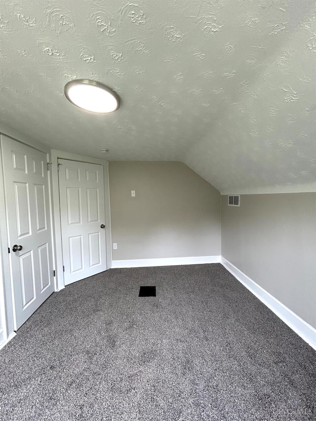 3501 Mcfarlan Rd, Cincinnati, OH 45211 - additional living space featuring dark colored carpet, a textured ceiling, and vaulted ceiling