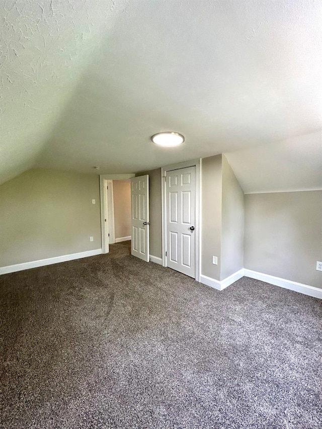 3501 Mcfarlan Rd, Cincinnati, OH 45211 - additional living space with dark carpet, lofted ceiling, and a textured ceiling