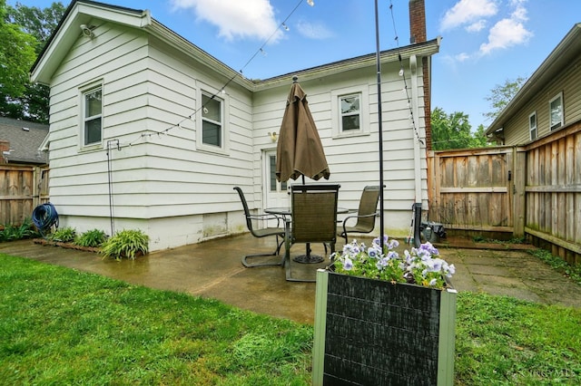 7002 Cambridge Ave, Columbia Twp, OH 45227 - rear view of house with a patio and a chimney