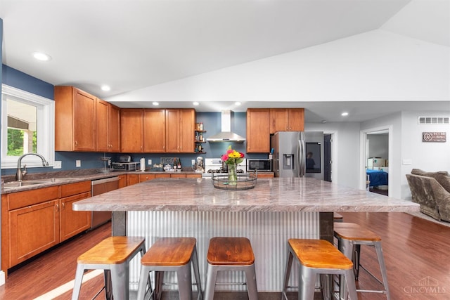 6226 Hunt Rd, Wayne Twp, OH 45118 - kitchen featuring appliances with stainless steel finishes, wall chimney range hood, vaulted ceiling, dark wood-style floors, and a kitchen island