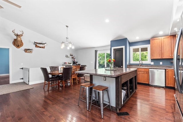 6226 Hunt Rd, Wayne Twp, OH 45118 - kitchen with appliances with stainless steel finishes, a breakfast bar, a center island, dark wood-type flooring, and recessed lighting