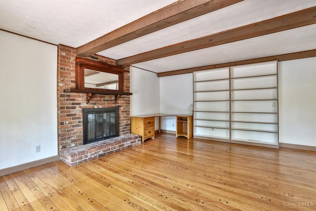 10730 Adventure Ln, Montgomery, OH 45242 - unfurnished living room with wood-type flooring, a fireplace, and beam ceiling
