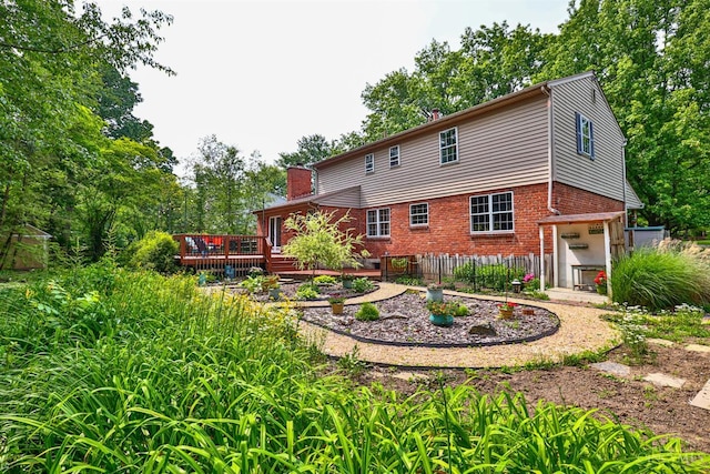 10730 Adventure Ln, Montgomery, OH 45242 - back of property with brick siding, a deck, and a chimney