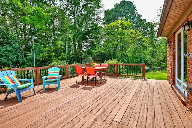 10730 Adventure Ln, Montgomery, OH 45242 - wooden terrace with outdoor dining space and view of wooded area