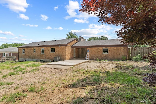 3494 Poole Rd, Colerain Twp, OH 45251 - back of house with a patio area, brick siding, and a chimney