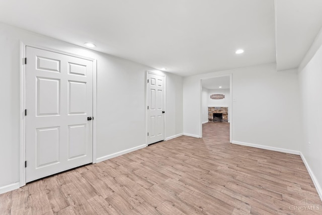 3494 Poole Rd, Colerain Twp, OH 45251 - below grade area featuring light wood-style floors, recessed lighting, and a stone fireplace
