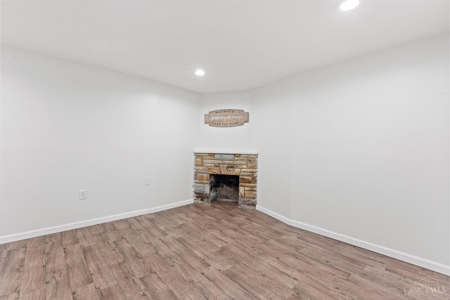 3494 Poole Rd, Colerain Twp, OH 45251 - unfurnished living room featuring wood finished floors, recessed lighting, and a stone fireplace