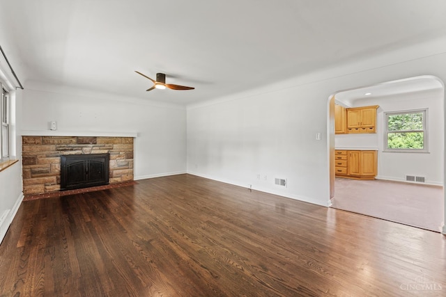 3494 Poole Rd, Colerain Twp, OH 45251 - unfurnished living room featuring ceiling fan, wood finished floors, a fireplace, and arched walkways