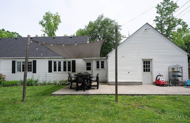 901 W Sunview Dr W, Hamilton, OH 45013 - back of property featuring a patio, a lawn, and roof with shingles