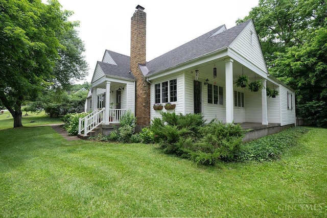 901 W Sunview Dr W, Hamilton, OH 45013 - view of property exterior featuring a yard, a chimney, covered porch, and a shingled roof