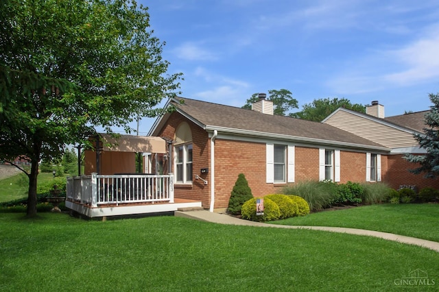1303 Crotty Ct Unit A, Anderson Twp, OH 45255 - view of property exterior featuring a deck, brick siding, a yard, a chimney, and roof with shingles