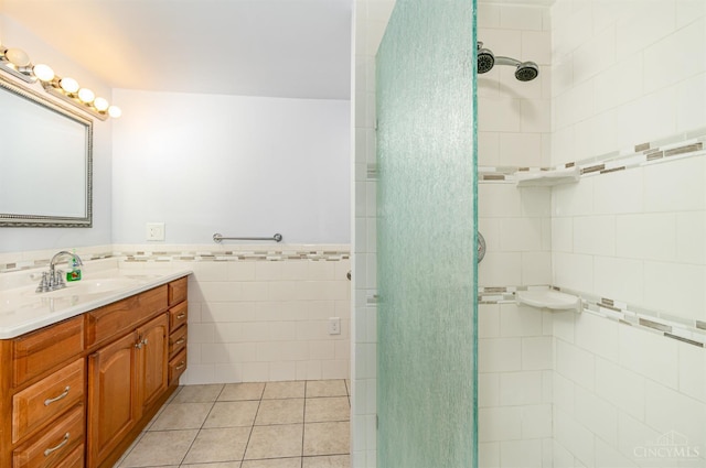 755 Jarole Dr, Union Twp, OH 45245 - bathroom with tile walls, vanity, a stall shower, tile patterned flooring, and a wainscoted wall