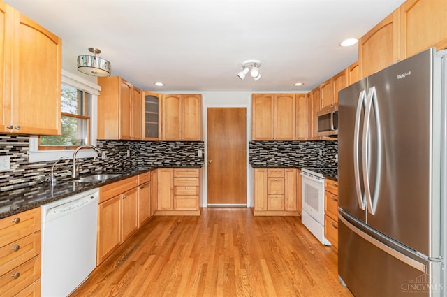 755 Jarole Dr, Union Twp, OH 45245 - kitchen with stainless steel appliances, light wood-type flooring, glass insert cabinets, decorative backsplash, and dark stone countertops