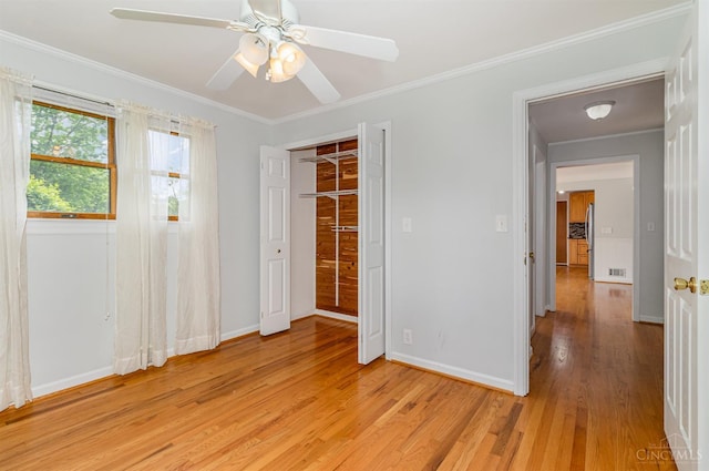 755 Jarole Dr, Union Twp, OH 45245 - unfurnished bedroom with light wood finished floors, ornamental molding, ceiling fan, freestanding refrigerator, and a closet