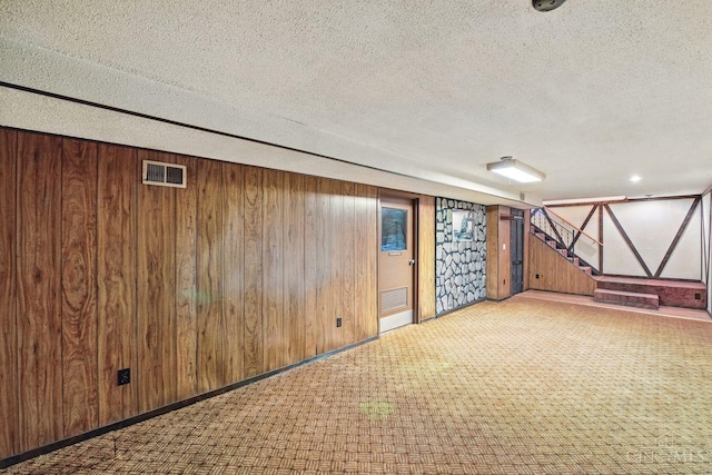 1704 Ludlow Cir, Pierce Twp, OH 45102 - finished below grade area with a textured ceiling, wooden walls, stairway, and carpet