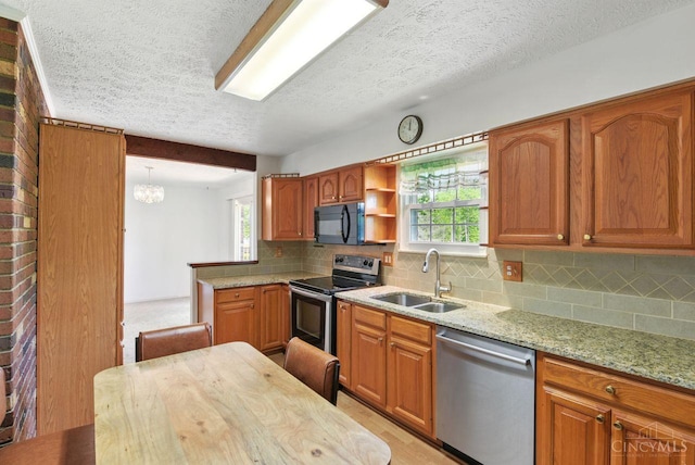 1704 Ludlow Cir, Pierce Twp, OH 45102 - kitchen with stainless steel appliances, a textured ceiling, healthy amount of natural light, tasteful backsplash, and light stone counters
