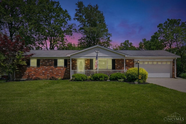 1704 Ludlow Cir, Pierce Twp, OH 45102 - single story home with a porch, brick siding, an attached garage, driveway, and a front yard