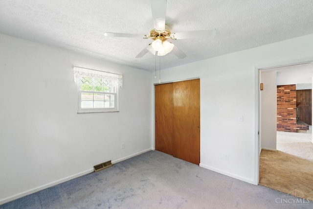 1704 Ludlow Cir, Pierce Twp, OH 45102 - unfurnished bedroom featuring carpet, a closet, a textured ceiling, and ceiling fan