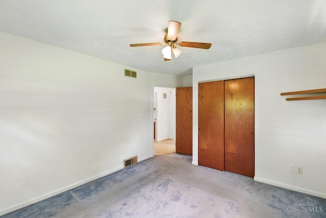 1704 Ludlow Cir, Pierce Twp, OH 45102 - unfurnished bedroom with a closet, carpet floors, ceiling fan, and a textured ceiling