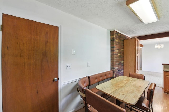 1704 Ludlow Cir, Pierce Twp, OH 45102 - dining area featuring a textured ceiling and a chandelier