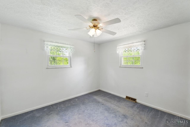 1704 Ludlow Cir, Pierce Twp, OH 45102 - unfurnished room with plenty of natural light, ceiling fan, a textured ceiling, and dark colored carpet