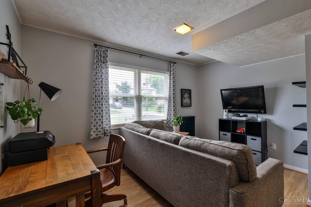 10569 Gloria Ave, Cincinnati, OH 45231 - living area with a textured ceiling and light wood finished floors