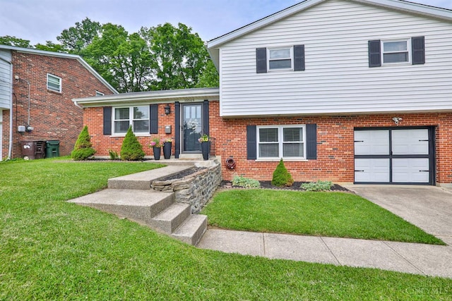 10569 Gloria Ave, Cincinnati, OH 45231 - tri-level home with a garage, a front yard, brick siding, and driveway