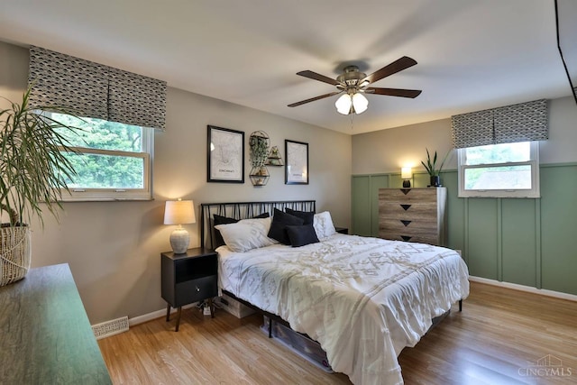 10569 Gloria Ave, Cincinnati, OH 45231 - bedroom featuring multiple windows, wood finished floors, and ceiling fan