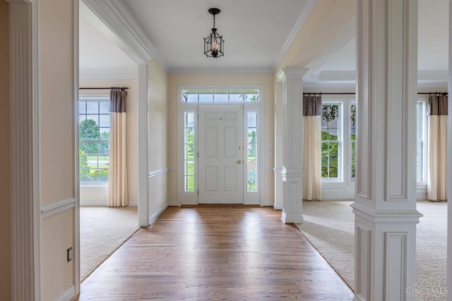 7194 Orchard View Ln, Salem Twp, OH 45152 - foyer with ornate columns, light carpet, light wood-type flooring, and ornamental molding