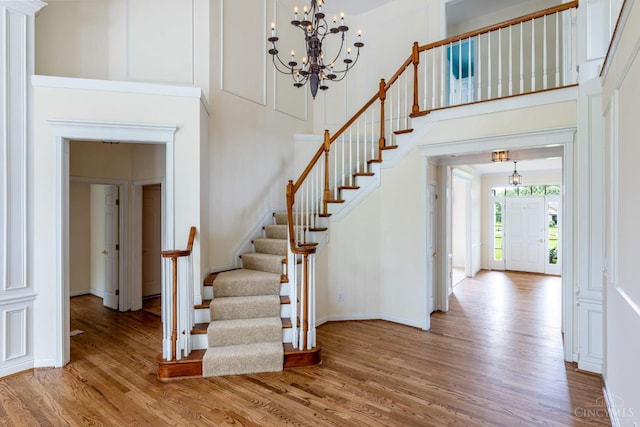 7194 Orchard View Ln, Salem Twp, OH 45152 - staircase with wood finished floors, a chandelier, and a towering ceiling